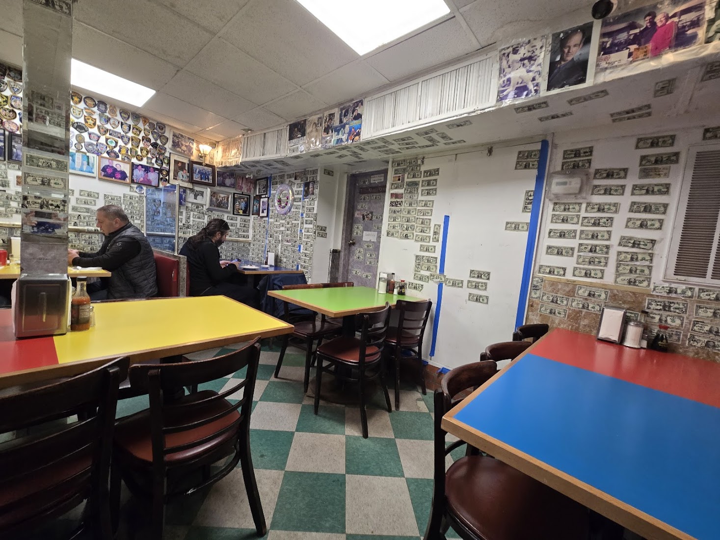 The famous Wo Hop dining room, walls papered with photos and dollar bills